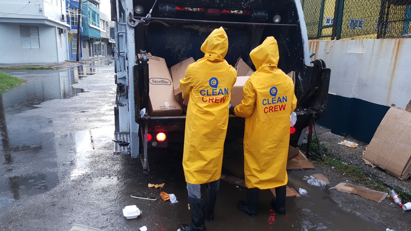 Clean Crew Jamaica team collecting waste in rainy conditions